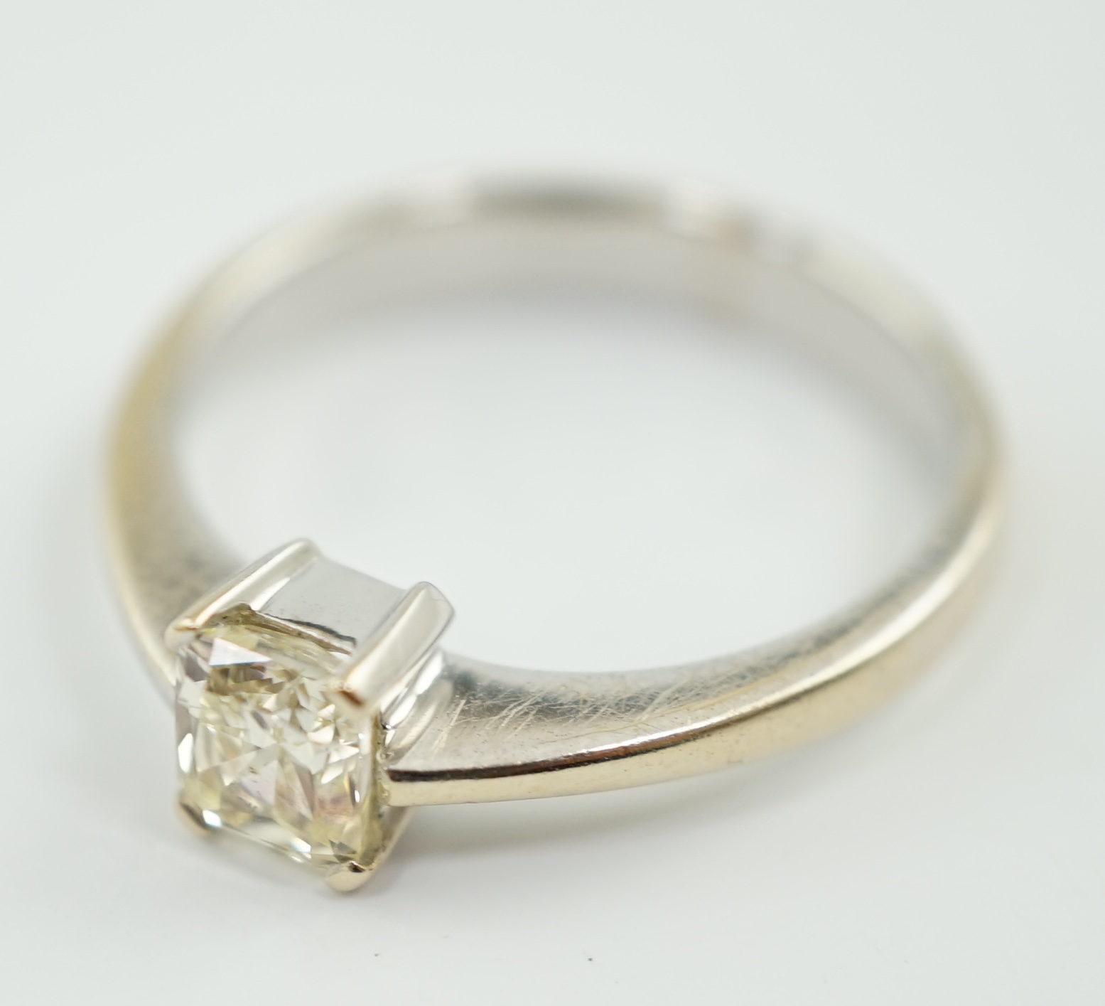 A modern 18k white gold and fancy rectangular cut pale yellow solitaire diamond set ring